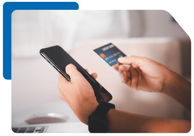a man making an online payment using his payment card and mobile phone